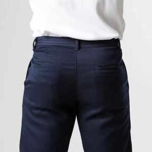 Detail view of navy blue casual trousers featuring twill fabric and back welt pockets