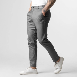 Detail of slim fit grey casual trousers showing high-quality twill fabric and side pockets