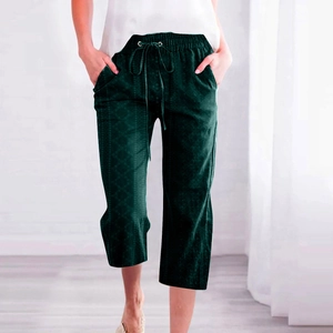 Close-up of deep green cropped trousers with elastic drawstring waist and side pockets
