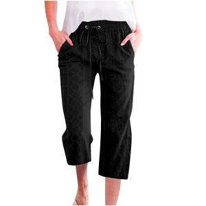 Detail of black drawstring waist cropped pants with side pockets and a relaxed straight fit