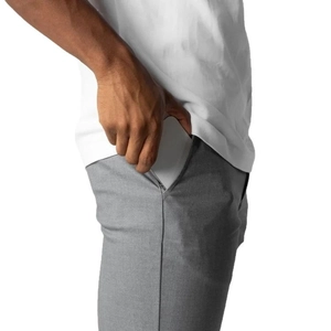 Men's casual grey business trousers featuring a side pocket holding a smartphone