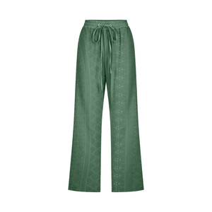 Detail view of dark green wide leg drawstring trousers with subtle geometric wave pattern