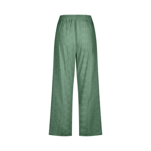 Detail of dark green wide-leg trousers showing elastic waistband and textured grid fabric