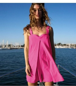 Detail view of rose red square neck sleeveless sundress on a yacht deck background