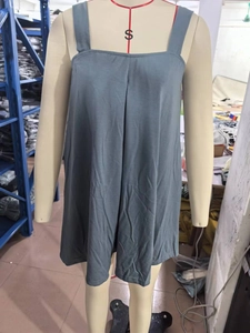 Detail of grey square neck sleeveless dress showing fabric texture on a mannequin