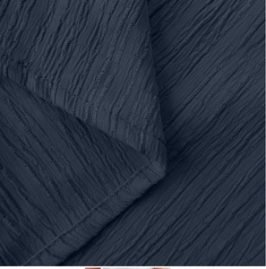 Detailed view of navy blue pleated fabric texture with professional stitched hem