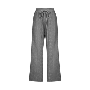 Detail of dark grey lounge pants featuring textured jacquard fabric and drawstring waist