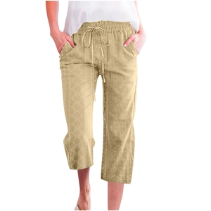 Detail of light khaki drawstring waist and geometric jacquard texture on capri pants