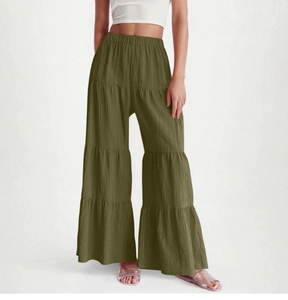 Detailed close-up of dark olive green wide-leg trousers with elastic high waist and tiered design