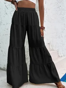 Women's black high-waisted tiered wide-leg trousers with pleated texture and elastic waist
