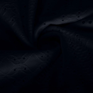 Detail of dark blue eyelet broderie anglaise fabric with decorative embroidery texture