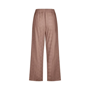 Detailed close-up of brown wide-leg trousers with diamond jacquard texture and elastic waist