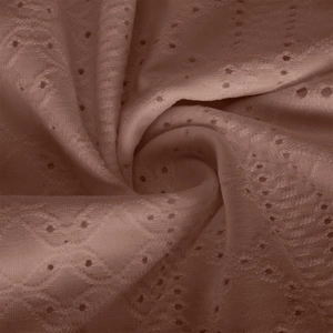 Macro texture of mauve open-knit fabric with hollow diamond mesh and wavy relief pattern