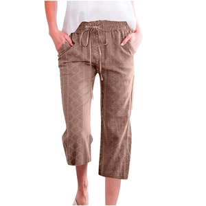 Close-up of women's brown geometric print cropped pants with drawstring waist and pockets