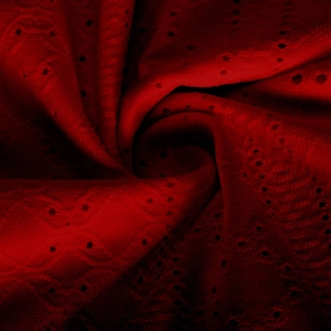 Macro shot of deep red hollow-out embroidery fabric with fine lace texture