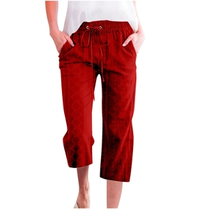 Detail of red drawstring casual pants showing textured geometric pattern and waist tie