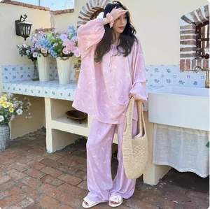Close-up of pink printed pajama set with elastic ruffles and soft drape fabric