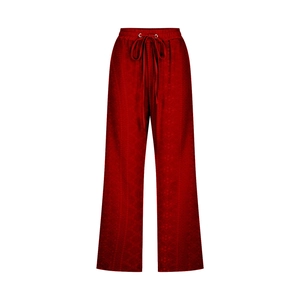 Detail of drawstring elastic waist and wine red textured fabric on women's loose pants