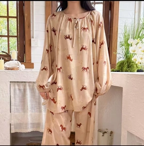 Close-up of lightweight printed pajama set featuring horse patterns and drawstring neckline