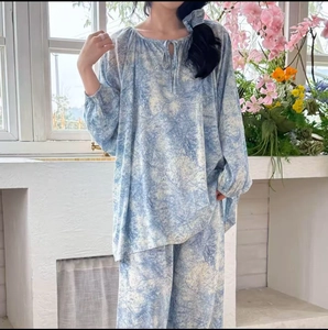 Detail of loose-fit printed cotton rayon pajama set with blue artistic pattern and tie-neck