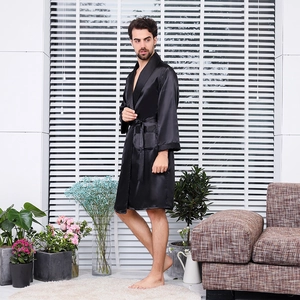 Men's black silk satin bathrobe with shawl collar and waist tie in a home setting