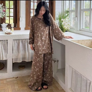 Detail of floral print on brown long-sleeve cotton-silk pajama set with draped pants