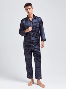 Detail of navy blue silk satin men's pajamas with golden polka dots and piping