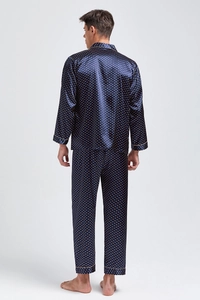 Detail of navy silk pajamas for men showing satin texture and gold polka dot prints