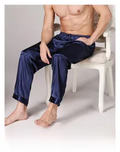 Detail of dark navy men's satin pajama pants with elastic waistband and smooth silk texture