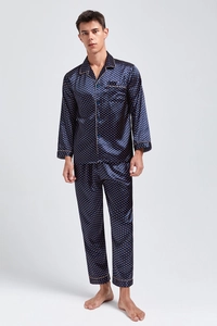 Close-up of men's dark blue silk pajamas with orange polka dots and polished buttons
