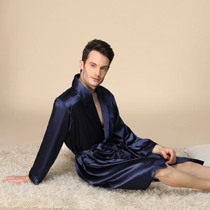 Luxurious dark blue silk satin men's long sleeve bathrobe with belt on plush carpet