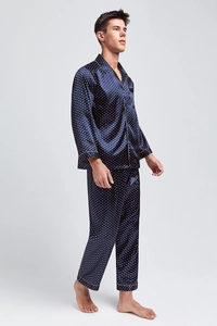 Close-up of men's dark blue silk pajama set with gold dots and white piping details