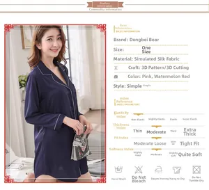 Detail of navy blue faux silk nightgown featuring a notch lapel and white contrast piping