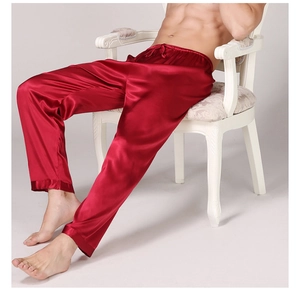 Men's red satin pajama pants featuring elastic drawstring waist and glossy finish texture