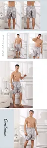 Detail view of men's satin sleep shorts with geometric pattern and elastic waistband
