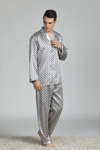 Detail view of men's satin pajama set featuring geometric prints and contrast trim piping