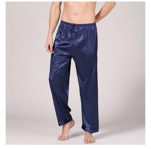 Detail of men's navy blue satin pajama pants with elastic waistband and drawstring cords