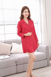 Detail of red silk satin nightshirt featuring white contrast piping and chest pocket