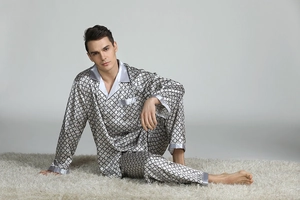 Detailed view of men's satin pajama set with gray geometric print and silk-like finish