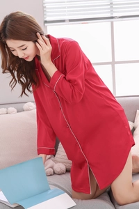 Detail of red silk satin long sleeve sleepshirt with white piping and button-up front