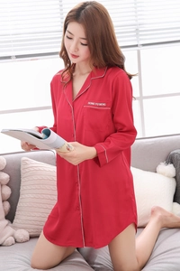 Detailed view of red silk satin nightshirt featuring white piping and embroidered pocket