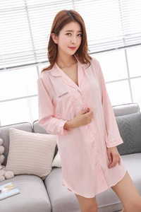 Detail of light pink silk satin long-sleeve nightgown with buttons and chest pocket