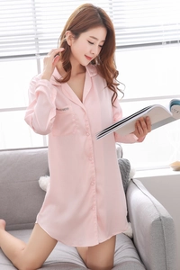 Detail of pink satin sleepshirt featuring a notched collar and embroidered pocket detail