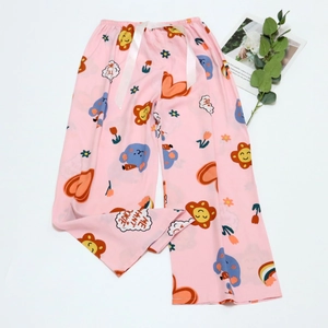 Detail of pink sleep pants featuring cartoon prints and a white satin drawstring waist