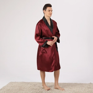 Detailed view of luxury wine red satin bathrobe with black contrast piping and belt