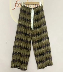 Detail view of cotton pajama pants with diamond plaid pattern and satin drawstring waist