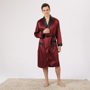 Detail view of men's burgundy silk robe with black contrast lapels and satin texture finish