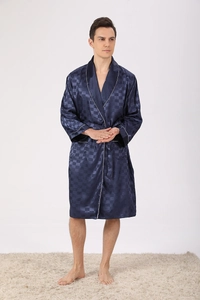 Detailed texture of dark blue silk bathrobe with jacquard pattern and white piping trim