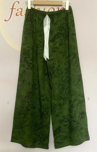 Detail of dark green floral wide-leg lounge pants with elastic waist and satin ribbon bow