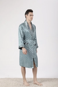 Detail of men's silk-like pajama robe with jacquard pattern and white piping trim
